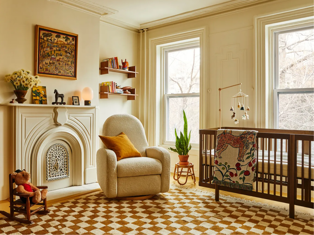 image of nursery room with Pogo All-Stages® 8-in-1 Convertible Crib in Natural Walnut and the Nami Electronic Swivel Glider and Recliner in Ivory Boucle