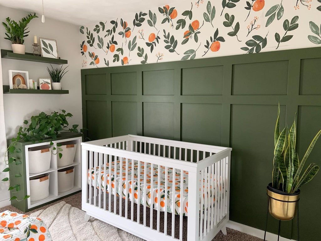 Botanical, fruit-themed farmhouse nursery with green board and batten. Featuring babyletto's Scoot Crib