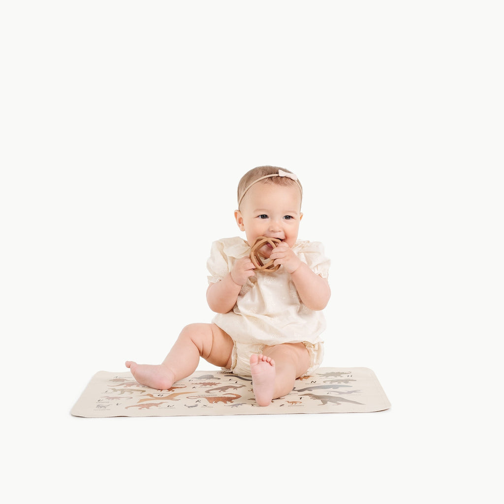 Image of a baby in a padded mat