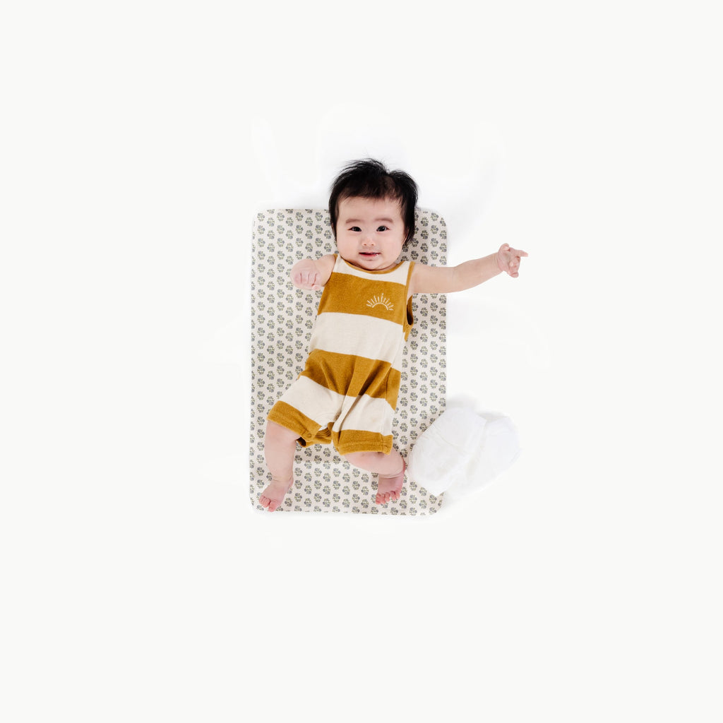 Image of a baby in a padded mat