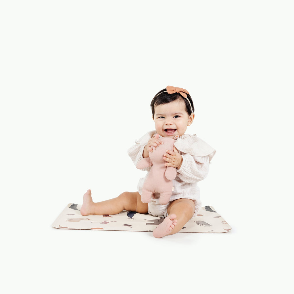 image of a baby sitting in a mat