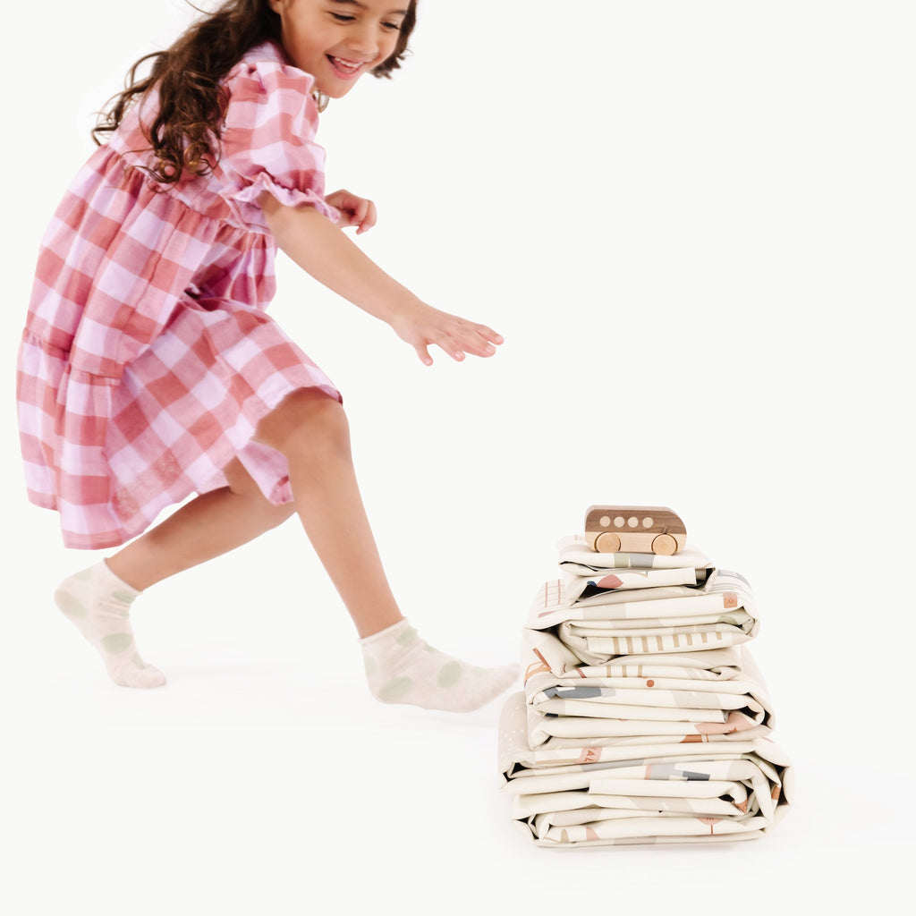 image of a baby playing with a toy in a stacked mat