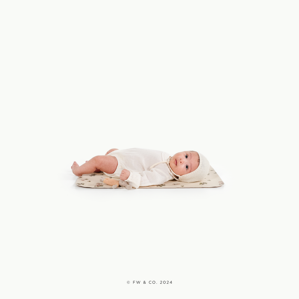 Image of a baby in a padded mat